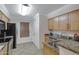 Updated kitchen with stainless steel appliances, granite countertops, and warm wood cabinets at 2025 E Campbell Ave # 114, Phoenix, AZ 85016
