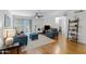 Bright living room with hardwood floors and contemporary furnishings including blue sofa and chairs at 2025 E Campbell Ave # 114, Phoenix, AZ 85016