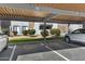 Assigned covered parking with view of the buildings and landscaping at 2025 E Campbell Ave # 114, Phoenix, AZ 85016