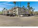 Complex parking with covered spots and palm tree landscaping at 2025 E Campbell Ave # 114, Phoenix, AZ 85016