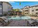 Inviting community swimming pool with lounge chairs and a covered patio area at 2025 E Campbell Ave # 114, Phoenix, AZ 85016