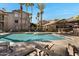 Community swimming pool with lounge chairs and manicured landscaping at 2025 E Campbell Ave # 114, Phoenix, AZ 85016