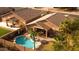 Aerial view of a backyard featuring a pool, patio, and lush landscaping, creating a private retreat at 203 W Raven Dr, Chandler, AZ 85286