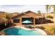 Backyard featuring a sparkling pool, lounging chairs, a covered patio, and well-maintained landscaping at 203 W Raven Dr, Chandler, AZ 85286