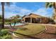 Expansive backyard featuring a pool, covered patio with furniture, and a lush green lawn at 203 W Raven Dr, Chandler, AZ 85286