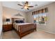 Comfortable bedroom with neutral walls, ceiling fan, and large window offering natural light at 203 W Raven Dr, Chandler, AZ 85286