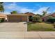Charming single-Gathering home with a well-maintained lawn, mature palms, and a two-car garage at 203 W Raven Dr, Chandler, AZ 85286