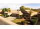 Inviting single-story home with a tile roof, well-manicured lawn, mature palm trees, and a two-car garage at 203 W Raven Dr, Chandler, AZ 85286