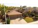 Well-maintained single-Gathering home with desert landscaping, tile roof, mature trees, and a two-car garage at 203 W Raven Dr, Chandler, AZ 85286