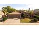 Charming single-Gathering home showcasing a large two-car garage, desert landscaping and inviting curb appeal at 203 W Raven Dr, Chandler, AZ 85286