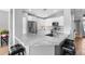 Modern kitchen featuring granite countertops, stainless steel appliances, ample white cabinetry, and eat in bar at 203 W Raven Dr, Chandler, AZ 85286