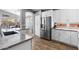 Modern kitchen with granite counters, stainless appliances, and stylish cabinetry with bright lighting at 203 W Raven Dr, Chandler, AZ 85286