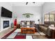Spacious living room featuring a fireplace, comfortable seating, and stylish decor at 203 W Raven Dr, Chandler, AZ 85286