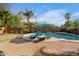 Relaxing backyard swimming pool with lounge chairs and beautiful landscaping for enjoyable outdoor living at 203 W Raven Dr, Chandler, AZ 85286