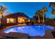 Backyard oasis featuring a sparkling blue pool, a covered patio and lush tropical landscaping for outdoor enjoyment at 203 W Raven Dr, Chandler, AZ 85286