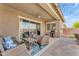 Comfortable outdoor patio featuring lounge seating, sliding glass doors, and built-in grill at 20340 E Camacho Rd, Queen Creek, AZ 85142
