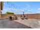 Spacious backyard boasting sleek lounge chairs, a dining set, and ambient string lights at 20340 E Camacho Rd, Queen Creek, AZ 85142