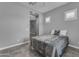 Modern bedroom with tile floors, neutral walls, bright natural light, and an open doorway at 20340 E Camacho Rd, Queen Creek, AZ 85142