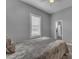 Bedroom featuring sleek flooring, large window with shutters, and ensuite bathroom at 20340 E Camacho Rd, Queen Creek, AZ 85142