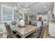 Well-lit dining area featuring a pendant light fixture and seating for six adjacent to kitchen at 20340 E Camacho Rd, Queen Creek, AZ 85142
