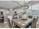Dining area with a view of the kitchen featuring a pendant light fixture and seating for six at 20340 E Camacho Rd, Queen Creek, AZ 85142