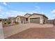 Charming single-story home with desert landscaping and a brick-paved driveway leading to the garage at 20340 E Camacho Rd, Queen Creek, AZ 85142