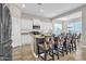 Gourmet kitchen with an extended island featuring breakfast bar seating, stainless steel appliances, and custom cabinetry at 20340 E Camacho Rd, Queen Creek, AZ 85142