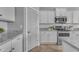 Close-up of a kitchen area with stainless steel appliances, white cabinets, and granite countertops at 20340 E Camacho Rd, Queen Creek, AZ 85142