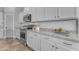 Well-appointed kitchen with stainless steel appliances, white cabinetry, and granite countertops at 20340 E Camacho Rd, Queen Creek, AZ 85142