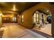 Inviting covered patio with hanging lights, rocking chairs, and access to the garage and back door at 21266 S 213Th Pl, Queen Creek, AZ 85142