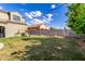 Grassy backyard with a playground area, garden beds, and privacy wall at 21266 S 213Th Pl, Queen Creek, AZ 85142
