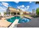 Well-manicured backyard with swimming pool, patio, and outdoor seating area for entertaining at 21266 S 213Th Pl, Queen Creek, AZ 85142