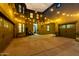Expansive outdoor patio with decorative string lights, multiple garages, and a cozy seating area at 21266 S 213Th Pl, Queen Creek, AZ 85142