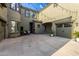 Spacious backyard area featuring multiple garages, concrete patio, and ample room for entertainment at 21266 S 213Th Pl, Queen Creek, AZ 85142