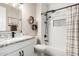 Stylish bathroom showcasing a tiled shower-tub, white vanity, and modern fixtures at 21266 S 213Th Pl, Queen Creek, AZ 85142