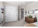 Neutral toned bedroom with closet, wooden dresser, and carpeted floor at 21266 S 213Th Pl, Queen Creek, AZ 85142