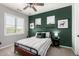 Cozy bedroom featuring a unique accent wall, window shutters, and stylish decor at 21266 S 213Th Pl, Queen Creek, AZ 85142