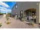 Home exterior featuring neutral stucco, dark trim, well-maintained landscape, and gravel ground cover at 21266 S 213Th Pl, Queen Creek, AZ 85142