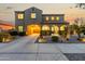 Inviting two-story home with a covered entryway, desert landscaping, and an attached two-car garage at dusk at 21266 S 213Th Pl, Queen Creek, AZ 85142