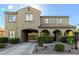 Charming two-story home featuring stucco siding, arched entryway, and manicured landscaping at 21266 S 213Th Pl, Queen Creek, AZ 85142