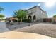 Beautiful two-story home featuring manicured landscaping, stone mulch, and an arched entryway at 21266 S 213Th Pl, Queen Creek, AZ 85142