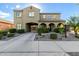 Charming two-story home featuring stucco siding, arched entryway, and manicured landscaping at 21266 S 213Th Pl, Queen Creek, AZ 85142