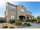 Charming two-story home featuring a porte-cochere and lush, manicured landscaping at 21266 S 213Th Pl, Queen Creek, AZ 85142