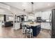 Well-lit kitchen with a blue island, white cabinets, pendant lighting, and stainless steel appliances at 21266 S 213Th Pl, Queen Creek, AZ 85142