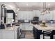 Bright, modern kitchen with an island, pendant lights, white cabinets, and stainless steel appliances at 21266 S 213Th Pl, Queen Creek, AZ 85142