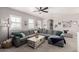 Open-concept living room with large sectional sofa, neutral decor, and plenty of natural light at 21266 S 213Th Pl, Queen Creek, AZ 85142