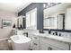 Bright main bathroom with double vanity, freestanding tub, and modern fixtures at 21266 S 213Th Pl, Queen Creek, AZ 85142