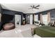 View of main bedroom with dark accent wall and view to bathroom and hallway at 21266 S 213Th Pl, Queen Creek, AZ 85142