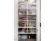 Organized pantry with shelving filled with various food items and kitchen supplies at 21266 S 213Th Pl, Queen Creek, AZ 85142