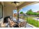 Covered patio area with outdoor dining set, grill, and view of the well-maintained backyard at 21266 S 213Th Pl, Queen Creek, AZ 85142